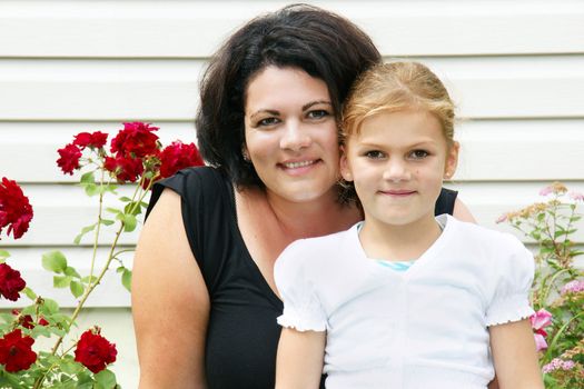 Beautiful mother and daughter portraits shot outdoors as they enjoy summer time.