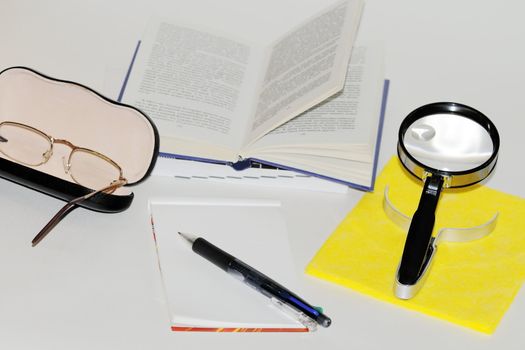 subjects to read a book, glasses, magnifying glass