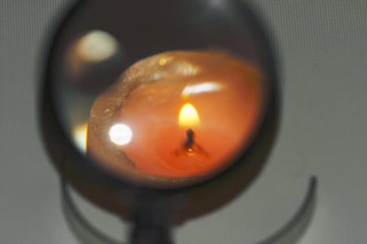 candle, a magnifying glass on a dark background