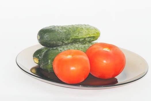 vegetables on a dark plate on a white background