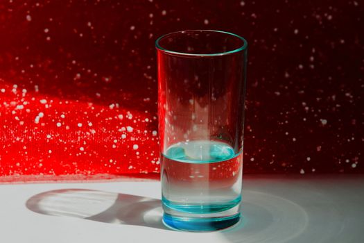 glass of water on a background of different colors