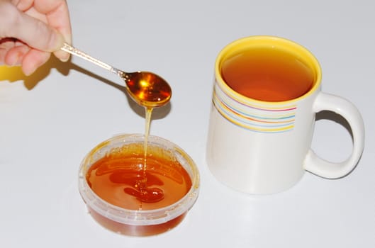 tea with honey on a white background