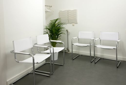 empty waiting room with white chairs