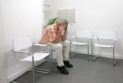 man sitting and waiting nervous in waitingroom