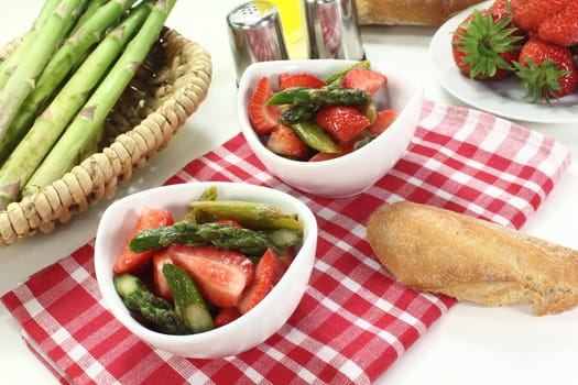 Asparagus salad with fresh strawberries, salt and pepper