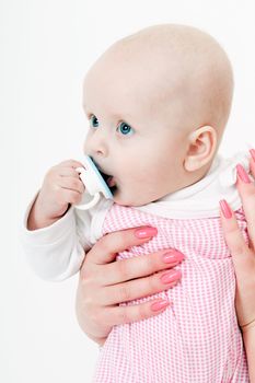 baby girl with a pacifier in her mother's hands