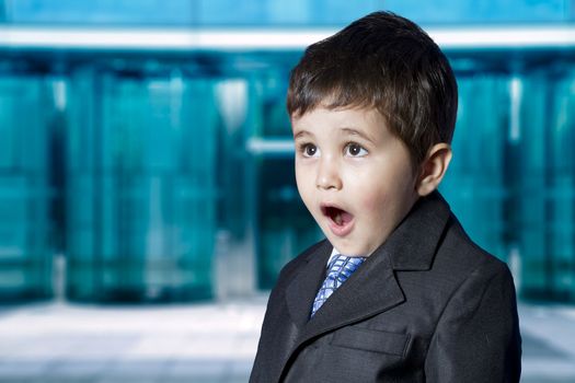 Stock Market. Surprised businessman child in suit with funny face