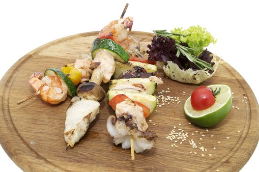 skewers of seafood on a wooden platter in a restaurant