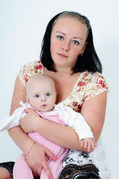 mother holding a baby daughter. studio photography