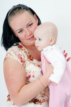 mother holding a baby daughter. studio photography