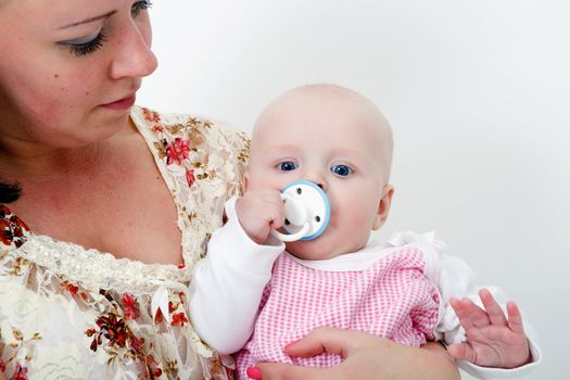 mother holding a baby daughter. studio photography