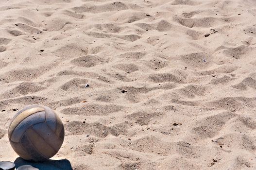 Old volleyball ball on the sand