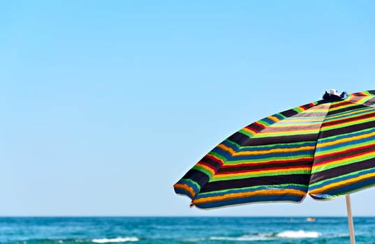 Umbrella on the background of the sea and sky