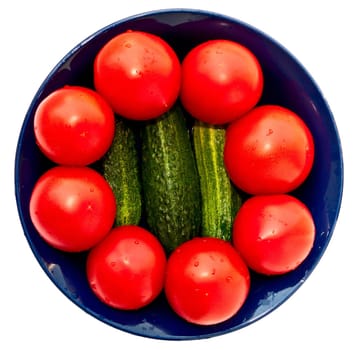 Blue salad bowl with fresh tomatoes and cucumbers, top view. Isolated on white.