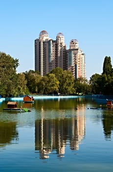 View of a modern house from a pond in Victory park, Odessa, Ukraine.