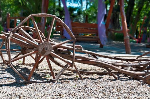 Model of an old and abandoned wooden carts. Garden decoration.