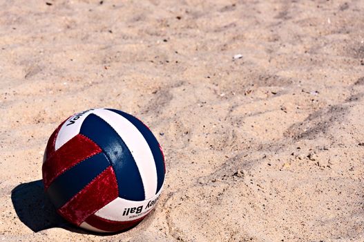 Volleyball ball on the sand. With space for text or image.