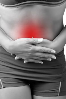 Woman suffering from stomach pain, isolated in white. Black and white with a red circle around the painful area.