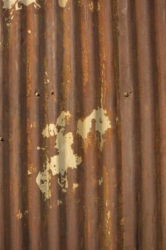 an old rusty damaged piece of metal roofing