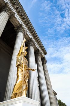 An image of a nice golden statue under a blue sky