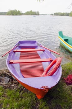 colorfull spring boat on lake near coast