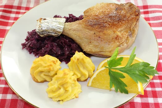 Duck leg with red cabbage and duchess potatoes