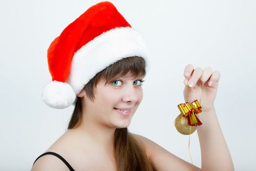 attractive girl in a Christmas hat with Christmas decorations