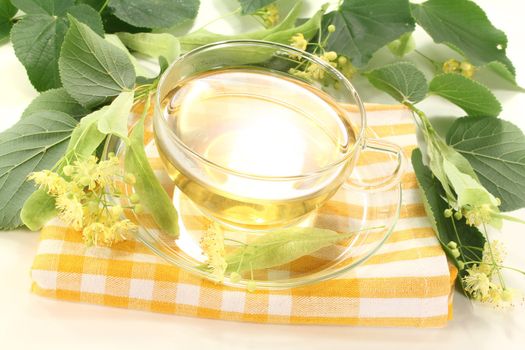 hot lime blossom tea with fresh flowers and leaves