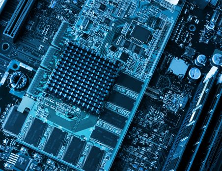 Computer components circuit board and processors closeup blue