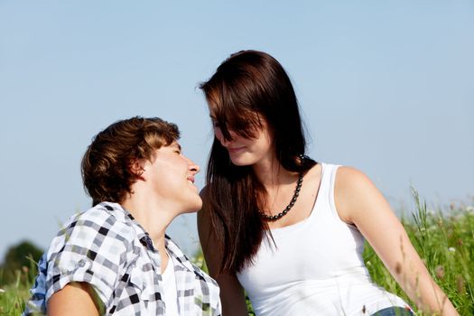 young couple outdoor in summer on blanket in love