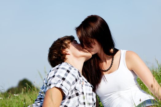 young couple outdoor in summer on blanket in love