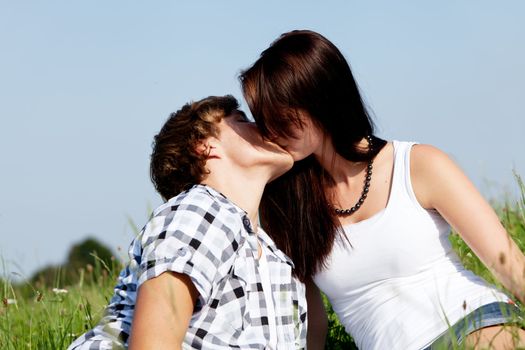 young couple outdoor in summer on blanket in love