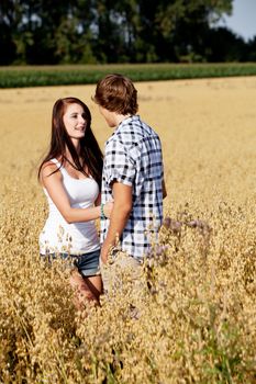 happy couple in love outdoor in summer on field having fun