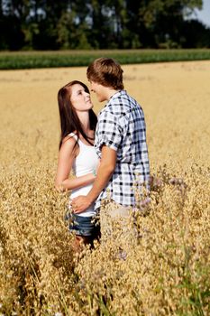 happy couple in love outdoor in summer on field having fun