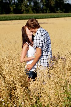 happy couple in love outdoor in summer on field having fun