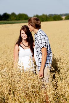 happy couple in love outdoor in summer on field having fun