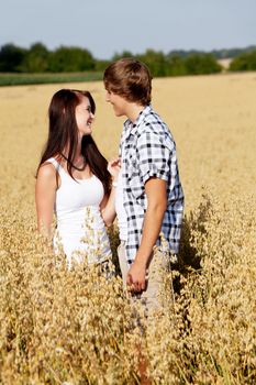 happy couple in love outdoor in summer on field having fun