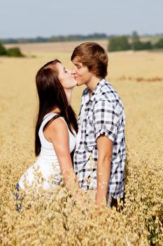 happy couple in love outdoor in summer on field having fun