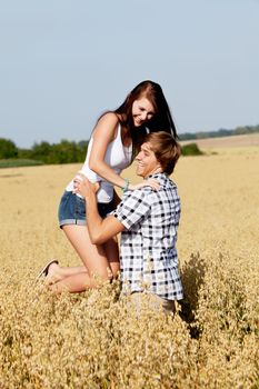 happy couple in love outdoor in summer on field having fun