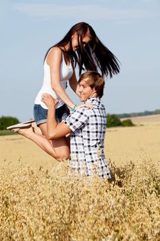 happy couple in love outdoor in summer on field having fun