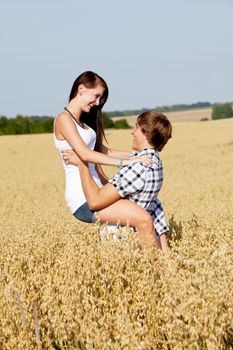 happy couple in love outdoor in summer on field having fun