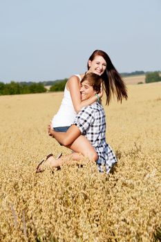 happy couple in love outdoor in summer on field having fun