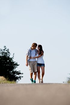 young woman and man is walking on  a road in summer outdoor happy