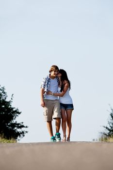 young woman and man is walking on  a road in summer outdoor happy