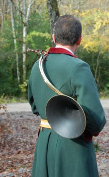 back of hunter in a traditional fox hunting with horn