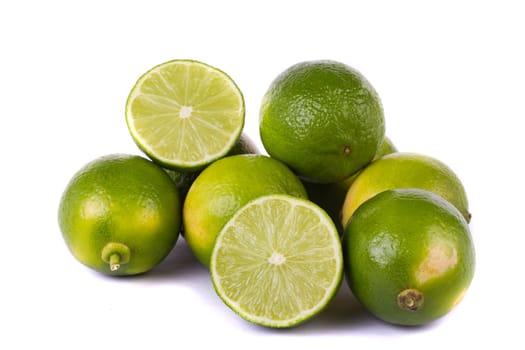 Close up view of a group of limes isolated on a white background.