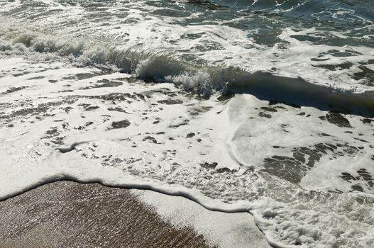 Closeup of beautiful white sea foam and waves