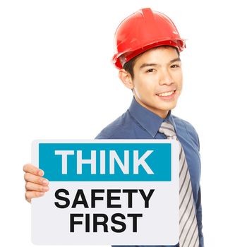 A man holding a sign with a safety message