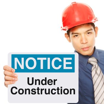 A man holding a safety sign indicating on-going repair or construction