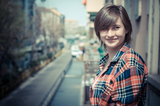 hipster girl on balcony smiling